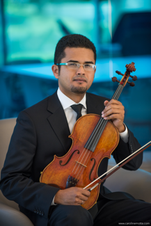 Photo of David Pedraza seated, holding a viola