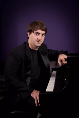 Photo of Alexander Bernstein sitting a piano